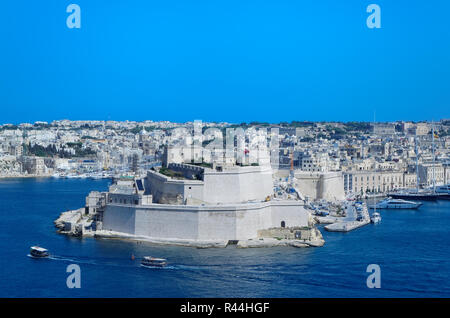 Ancient limestone walls and towers of Fort St Angelo from Upper Barrakka Gardens. Valletta, European island state of Malta Stock Photo