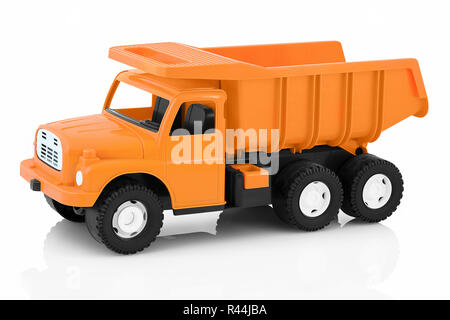 Vintage dump truck isolated on white background with shadow reflection. Plastic child toy on white backdrop. Dump tipper truck lorry construction vehi Stock Photo