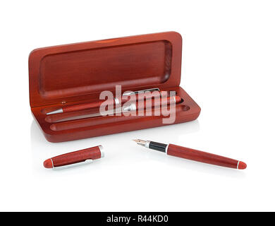 Elegant wooden ballpoint pen, fountain pen, letter opener in an opened wooden case isolated on white background with shadow reflection. Luxury box wit Stock Photo