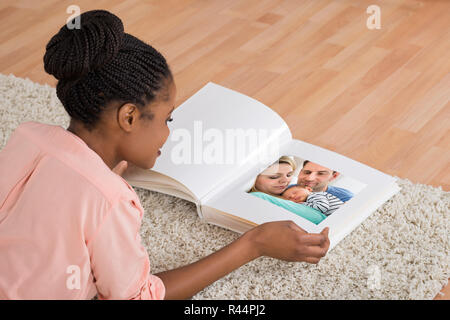 Woman Looking At Photo Album Stock Photo