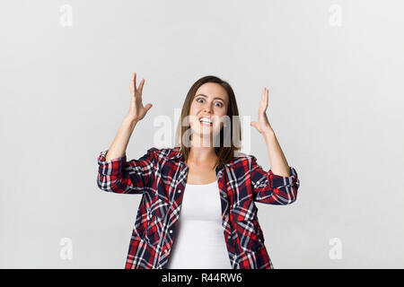 Beautiful young brunette upset woman isolated on white background. Studio shot Stock Photo