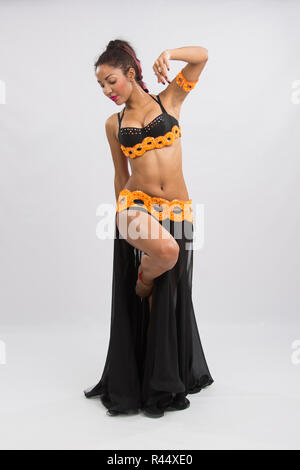 Young girl mulatto dancing in a long black dress candid Stock Photo