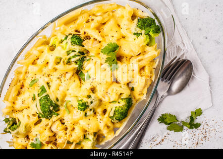 Casserole with pasta, chicken, broccoli and cheese crust in a glass form, white background. Stock Photo