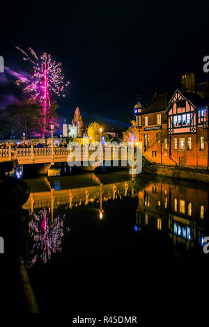 Tonbridge, Kent, England. 25 November 2018. The firework show in front of Tonbridge Castle lawn to mark the switch on of the Tonbridge Chirstmas lights. Photo taken adjacent to the river Medway with Tonbridge Castle in the distance, light up at night. Sarah Mott / Alamy Live News Stock Photo