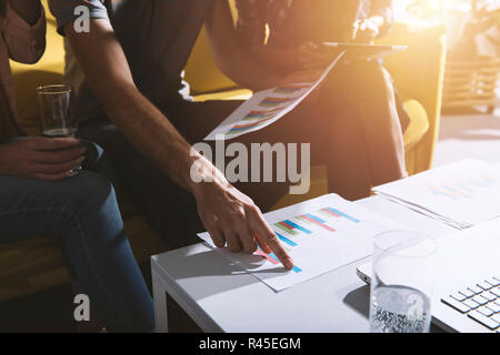 Team of business person works together on company statistics. Concept of teamwork Stock Photo