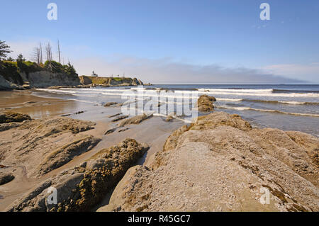 Rocks and Waves on a Sheltered Beach Stock Photo
