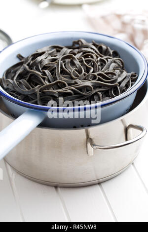 cooked black noodles with squid sepia ink