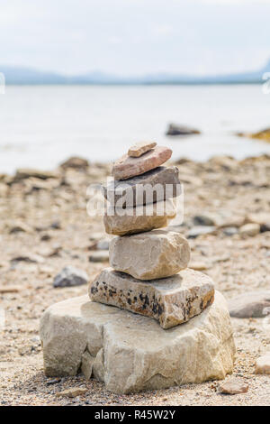 Balance and harmony: stacked stones on the beach Stock Photo