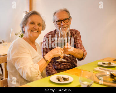Old couple toasting Stock Photo
