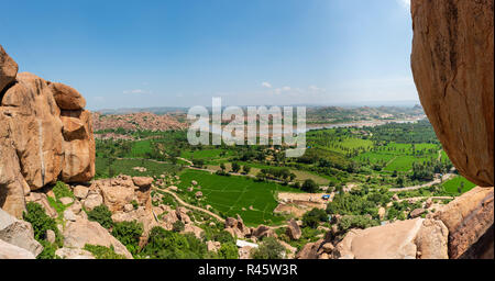 View of the tungabhadra river with its surrounding fields from mountain top in Hampi India Stock Photo