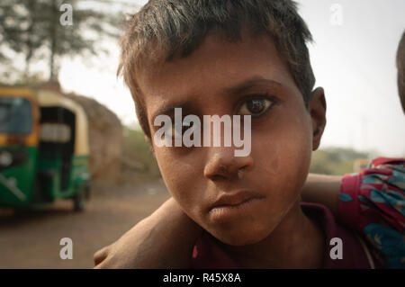 Boy and his friend with a tuktuk. Agra, India Stock Photo