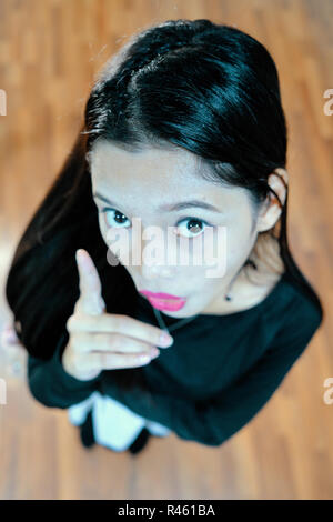 Beautiful woman posing - look up, facial expression, pointing, shocked Stock Photo