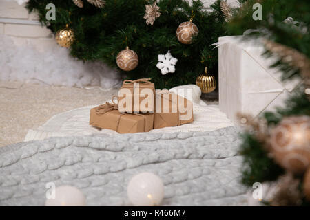 Handmade gift boxes on floor near fir tree Stock Photo