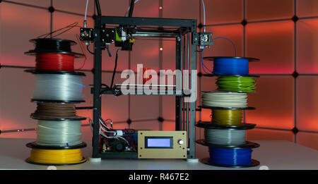 3d printer and plastic filament on color background Stock Photo