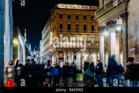 Long exposure of xmas shoppers at Corso Vittorio Emanuele ii near Duomo in Milan, Lombardy, Italy on a cold November night Stock Photo
