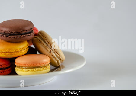 Colorfull macaroons are on the white plate,copy space, Stock Photo