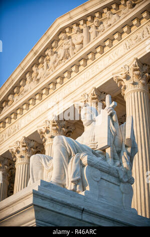 Scenic afternoon view of the facade of the US Supreme Court Building with golden sunset light falling on classical Corinthian columns and statue Stock Photo