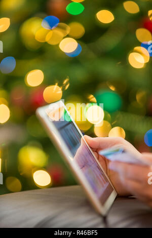 Holiday shopping using tablet Stock Photo