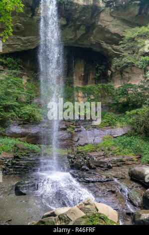 Small waterfall hitting and splash on the surface of hard rocks, near Taipei, Taiwan - On a sunny day during summer time Stock Photo