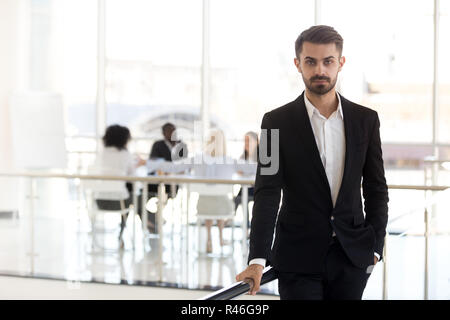 Serious millennial corporate leader or executive ceo looking at  Stock Photo
