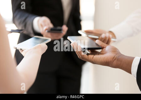 Business office people standing in circle using mobile phones Stock Photo