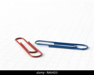 close up.blue and red paper clips on the background of notebook  Stock Photo