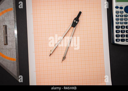 A circle laying on millimeter paper on black background Stock Photo
