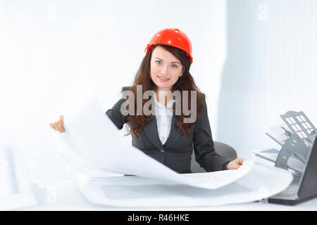 businesswoman making blueprint at desk in office Stock Photo