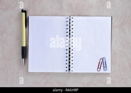open Notepad and colored pencils on paper background.photo with copy space Stock Photo