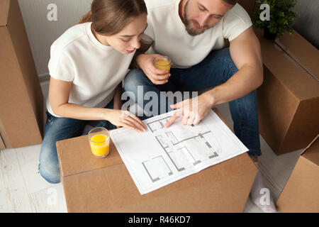 Young couple discussing house architectural plan top view Stock Photo