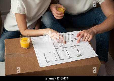 Young couple discussing house architectural plan close up Stock Photo