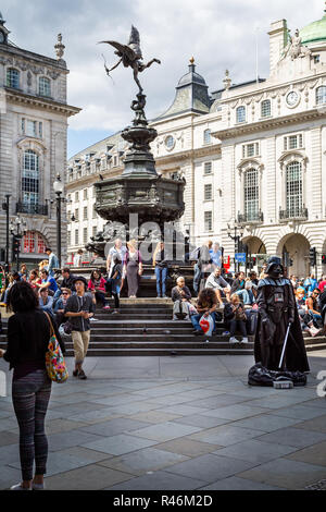 Statue of Eros or Anteros  with Darth Vader street performer in Picadilly Circus, London, UK on 12 August 2013 Stock Photo