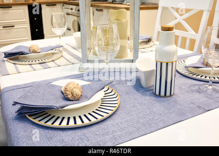 Served table with blue dishes on a blue white tablecloth Stock Photo