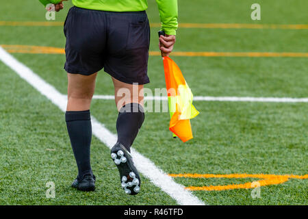 Assistant referee hold flag Stock Photo