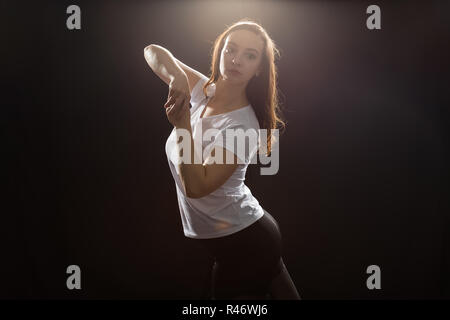 Young woman jazz funk dancer exercising dance moves in studio Stock Photo