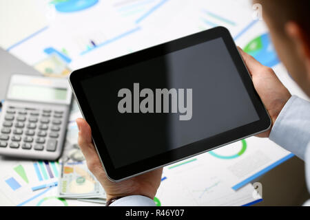 Businessman holds tablet on background Stock Photo