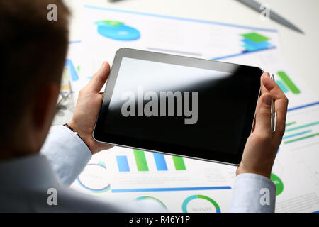 Businessman holds tablet on background Stock Photo