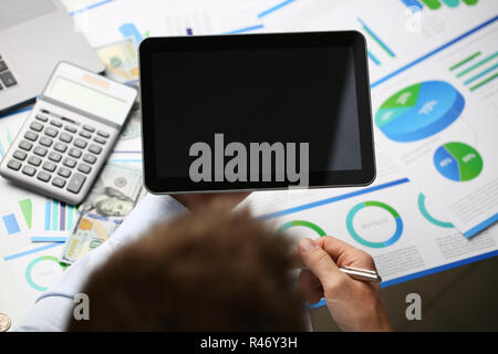 Businessman holds tablet on background Stock Photo