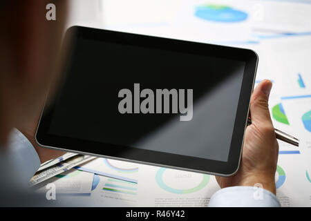Businessman holds tablet on background Stock Photo