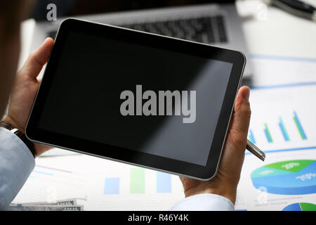 Businessman holds tablet on background Stock Photo