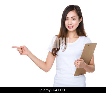 Woman hold with clipboard and finger point aside Stock Photo