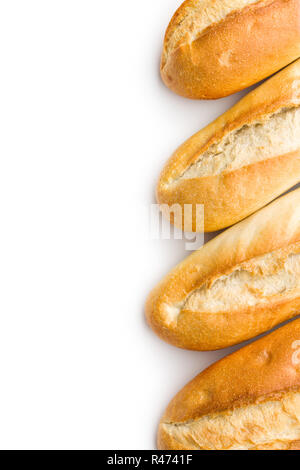 Top view of a crusty baguette peeking out from a brown paper bag ...
