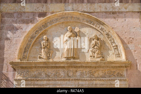 Bas relief on the Basilica of Saint Francis in Assisi, Umbria, central Italy. Stock Photo