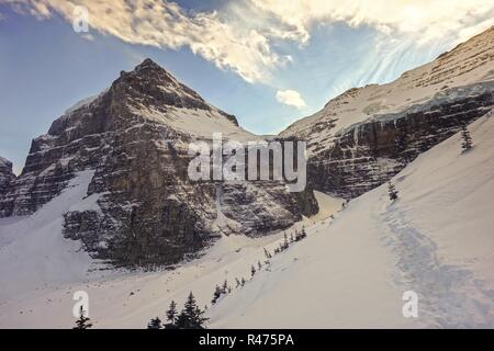 Snowshoeing Slope Tracks, Rocky Mountain Peaks, White Winter Snow Landscape.  Plain of Six Glaciers Hiking Banff National Park, Canadian Rockies Stock Photo