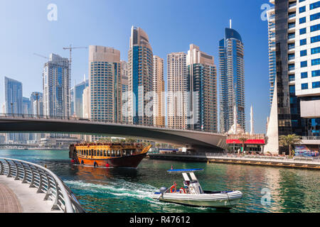 Dubai Marina with boats against skyscrapers in Dubai, United Arab Emirates Stock Photo