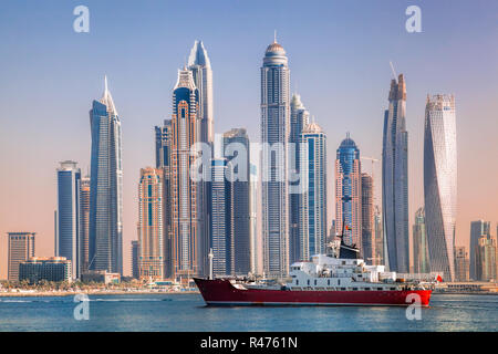 Panorama of Dubai with ship against skyscrapers in UAE Stock Photo