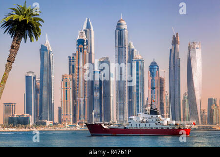 Panorama of Dubai with ship against skyscrapers in UAE Stock Photo