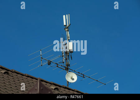 television antenna and wi-fi transmitter on the roof Stock Photo