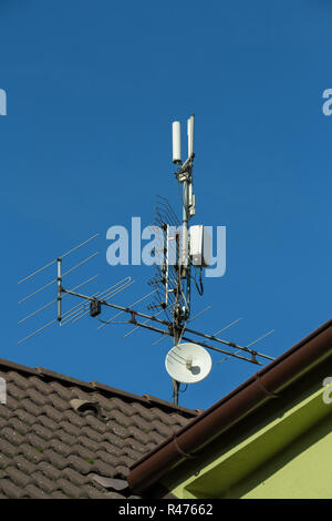 television antenna and wi-fi transmitter on the roof Stock Photo