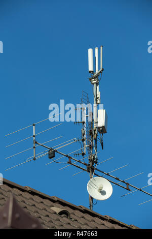 television antenna and wi-fi transmitter on the roof Stock Photo